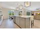 Spacious kitchen with a large island, modern appliances, and stylish pendant lighting, creating a perfect culinary space at 13330 Panama Beach Ct, Orlando, FL 32827
