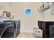 Laundry room featuring washer and dryer, wire shelves, and a window at 13330 Panama Beach Ct, Orlando, FL 32827