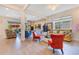 Spacious living room with large windows, stylish furniture, and a decorative ceiling fan at 13330 Panama Beach Ct, Orlando, FL 32827