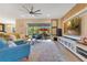 Bright living room with large windows, stylish furniture, and a television console at 13330 Panama Beach Ct, Orlando, FL 32827
