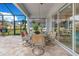 Covered patio featuring a dining table with seating and views of the backyard at 13330 Panama Beach Ct, Orlando, FL 32827
