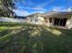 Backyard featuring well-maintained lawn, privacy fence, and covered patio at 1432 Stargazer Ter, Sanford, FL 32771
