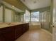 Bathroom with double vanity, soaking tub, and glass-enclosed shower at 1432 Stargazer Ter, Sanford, FL 32771