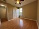Cozy bedroom featuring hardwood floors, closet, and a window at 1432 Stargazer Ter, Sanford, FL 32771
