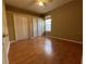 Neutral bedroom with wood floor features closet with double doors and a ceiling fan at 1432 Stargazer Ter, Sanford, FL 32771