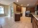 Open kitchen with stainless steel appliances and tile flooring at 1432 Stargazer Ter, Sanford, FL 32771