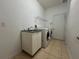 Bright laundry room featuring tiled floor, sink, and washer/dryer at 1432 Stargazer Ter, Sanford, FL 32771
