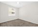 A simple bedroom featuring neutral carpet, window and ceiling fan at 16780 Meadows St, Clermont, FL 34714