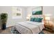Stylishly staged bedroom features calming decor, neutral walls, and ample natural light at 16780 Meadows St, Clermont, FL 34714