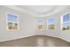 Bright room with neutral walls, tile floors, and a tray ceiling features three large windows at 16780 Meadows St, Clermont, FL 34714