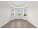 Bright room with neutral walls, tile floors, and a tray ceiling features three large windows at 16780 Meadows St, Clermont, FL 34714