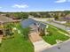 Charming single-story home with a brick driveway, well-manicured lawn, and vibrant landscaping at 16780 Meadows St, Clermont, FL 34714