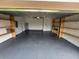 Spacious garage features built-in shelving and epoxy flooring at 16780 Meadows St, Clermont, FL 34714