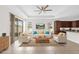 Open floor plan features tile flooring, a kitchen with an island, and a comfortable seating arrangement at 16780 Meadows St, Clermont, FL 34714