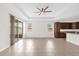 Spacious living room with tile floors, tray ceiling, ceiling fan, and sliding glass doors at 16780 Meadows St, Clermont, FL 34714