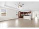 Open floor plan features tile flooring, a kitchen with an island, and tray ceilings throughout the living area at 16780 Meadows St, Clermont, FL 34714