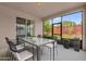 Covered patio featuring a modern table and chairs, with views of the backyard at 16780 Meadows St, Clermont, FL 34714
