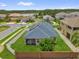 Well-maintained home featuring a fenced backyard, screened lanai, and solar panels on the roof at 16780 Meadows St, Clermont, FL 34714