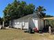 Exterior view of home featuring white siding and overgrown lawn at 1708 W 16Th St, Sanford, FL 32771