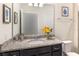 Bathroom featuring granite countertops, a framed mirror, and decorative wall art at 1820 Summer Dr, Davenport, FL 33897
