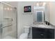 This bathroom features a glass door walk-in shower, granite countertops, and updated fixtures at 1820 Summer Dr, Davenport, FL 33897