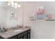 Bathroom featuring a vanity with granite countertop, a framed mirror, and decorative art at 1820 Summer Dr, Davenport, FL 33897