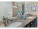 Bright bathroom featuring a double vanity with granite countertops and modern fixtures plus a glass shower door at 1820 Summer Dr, Davenport, FL 33897