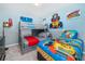 Fun bedroom featuring a bunkbed and twin, decorated with colorful cartoon themed art at 1820 Summer Dr, Davenport, FL 33897