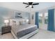 Bedroom featuring a large bed, neutral tones and textures, and light-filled windows at 1820 Summer Dr, Davenport, FL 33897