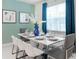 Bright dining room with white table and six chairs and large bright window at 1820 Summer Dr, Davenport, FL 33897