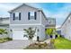 Charming two-story home with manicured lawn, beautiful landscaping, and a paved driveway at 1820 Summer Dr, Davenport, FL 33897