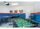Enjoy the ultimate game night in this vibrant room with foosball, air hockey, and ping pong tables at 1820 Summer Dr, Davenport, FL 33897