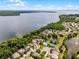A scenic aerial view captures waterfront homes and lush greenery along a tranquil lake with stunning natural beauty at 212 Tavestock Loop, Winter Springs, FL 32708