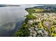 Beautiful aerial view of lakefront homes and community amenities with lush green landscaping and gorgeous water views at 212 Tavestock Loop, Winter Springs, FL 32708