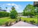 A charming backyard patio offers serene views of the pond and lush greenery, creating a peaceful retreat at 212 Tavestock Loop, Winter Springs, FL 32708