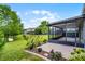 A beautifully landscaped backyard features a screened lanai and a serene pond view, ideal for outdoor enjoyment at 212 Tavestock Loop, Winter Springs, FL 32708