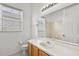 Bathroom with a large mirror, vanity, and ample lighting featuring a toilet at 212 Tavestock Loop, Winter Springs, FL 32708