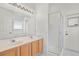 Bathroom with double sinks, vanity, glass shower, and access to the outdoor area at 212 Tavestock Loop, Winter Springs, FL 32708