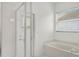 Bright bathroom with a shower, large tub, and a window for natural lighting at 212 Tavestock Loop, Winter Springs, FL 32708