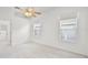 Sunny bedroom with carpet, a ceiling fan, and natural light from the dual windows at 212 Tavestock Loop, Winter Springs, FL 32708