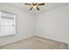 A cozy bedroom bathed in natural light featuring plush carpet and a ceiling fan at 212 Tavestock Loop, Winter Springs, FL 32708