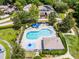 An aerial view showcases a community pool and recreation area with ample seating and lush landscaping at 212 Tavestock Loop, Winter Springs, FL 32708