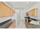 Well-lit kitchen featuring plenty of cabinet space and granite countertops with modern appliances at 212 Tavestock Loop, Winter Springs, FL 32708