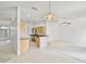 Open-concept kitchen with wood cabinetry, stainless steel appliances, and breakfast bar area at 212 Tavestock Loop, Winter Springs, FL 32708