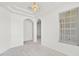 Bright living area with white walls, carpeted floor, modern lighting, and arched doorways at 212 Tavestock Loop, Winter Springs, FL 32708