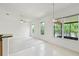 Bright living space with tile flooring, white walls, ceiling fans, and a view of the outdoors at 212 Tavestock Loop, Winter Springs, FL 32708