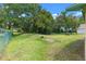 Large backyard surrounded by a chain link fence and mature trees at 2213 Bates Ave, Eustis, FL 32726
