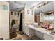 Spacious bathroom with a long vanity, decorative mirror, and tile flooring at 2213 Bates Ave, Eustis, FL 32726