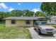 Charming single-story home with a well-maintained lawn and colorful exterior accents at 2213 Bates Ave, Eustis, FL 32726