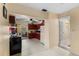 An open-concept kitchen with a doorway to a bathroom on the right at 2213 Bates Ave, Eustis, FL 32726